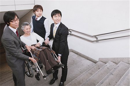 family stairs - People Helping  Woman On Wheelchair Stock Photo - Rights-Managed, Code: 859-03599628