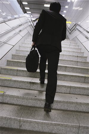 run suit low angle - Businessman Running Stairs Stock Photo - Rights-Managed, Code: 859-03599623