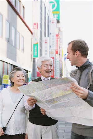 sight seeing with family - Senior Couple Guiding Stock Photo - Rights-Managed, Code: 859-03599638