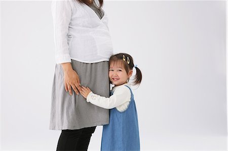 pregnant toddler holding - Girl Hugging her Mother Stock Photo - Rights-Managed, Code: 859-03600056