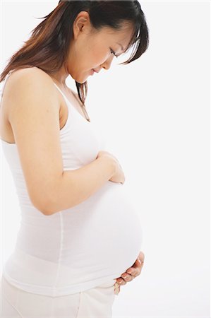 pregnant asian - Pregnant Woman Touching her Stomach Stock Photo - Rights-Managed, Code: 859-03600078