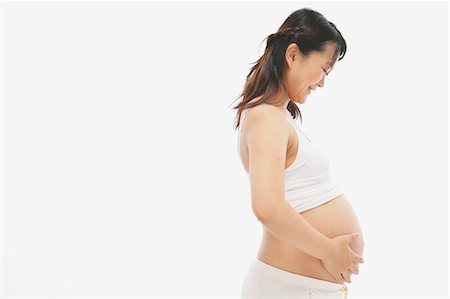 pregnant asian pic - Pregnant Woman Smiling while Touching her Belly Stock Photo - Rights-Managed, Code: 859-03600086