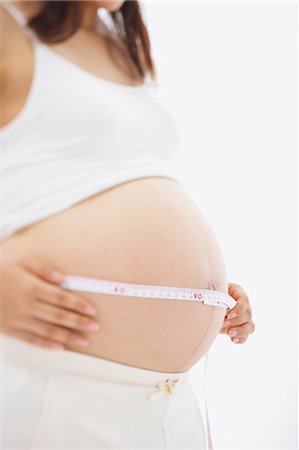 simsearch:859-03600068,k - Pregnant Woman Measuring her Stomach Fotografie stock - Rights-Managed, Codice: 859-03600090