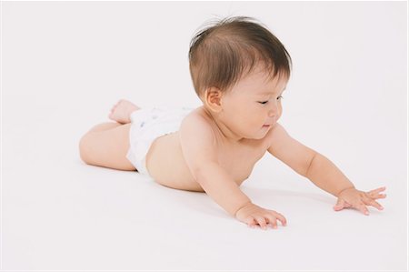 simsearch:859-03600167,k - Baby Lying On Front Foto de stock - Direito Controlado, Número: 859-03600171