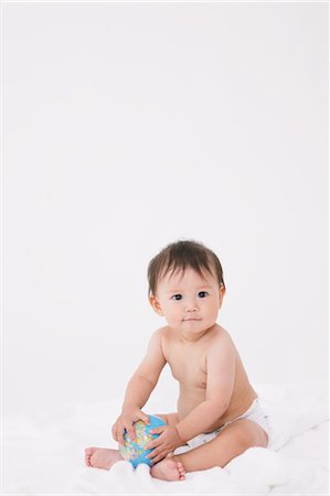 portrait on white sheet - Baby Griping Earth Ball Stock Photo - Rights-Managed, Code: 859-03600222