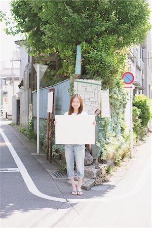Japanese Woman Holding A Whiteboard Stock Photo - Rights-Managed, Code: 859-03730617