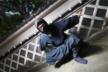 Masked Ninja Crouching By Wall Stock Photo - Rights-Managed, Code: 859-03730697