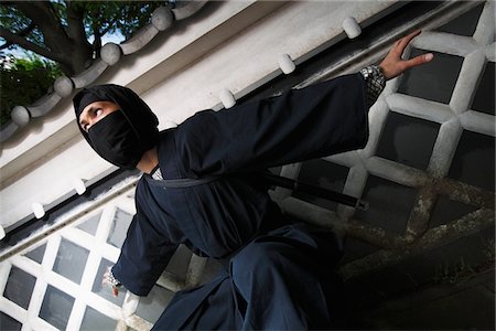 Masked Ninja Crouching By Wall Stock Photo - Rights-Managed, Code: 859-03730699