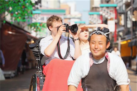 running into the camera - Young Couple Sitting In Rickshaw In Asakusa, Japan Stock Photo - Rights-Managed, Code: 859-03730834