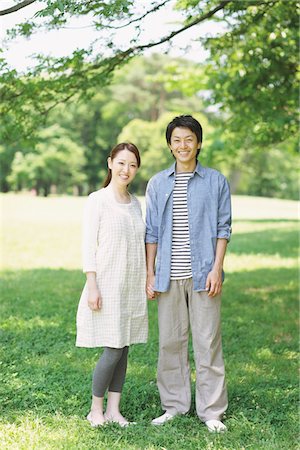 Young Couple Standing In a Park Stock Photo - Rights-Managed, Code: 859-03755370