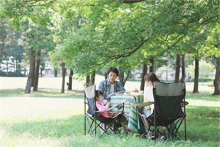 eating outside young - Family Eating Food Picnic In a Field Stock Photo - Rights-Managed, Code: 859-03755407