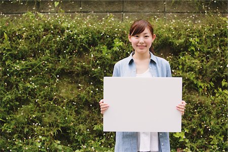 placard not illustration and one person - Young Woman Holding Whiteboard Stock Photo - Rights-Managed, Code: 859-03779848