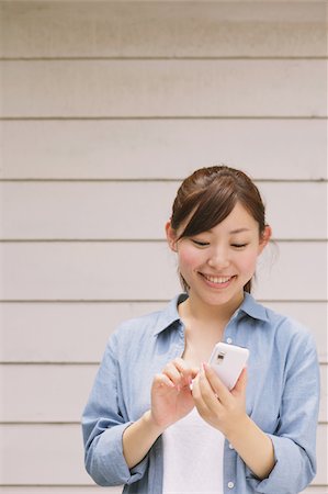 Young Woman Texting On Cell Phone Stock Photo - Rights-Managed, Code: 859-03779866