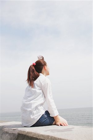 Young Woman Sitting And Looking By The Sea Stock Photo - Rights-Managed, Code: 859-03779910