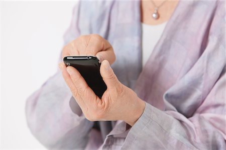 Woman Using Touch Screen Phone Stock Photo - Rights-Managed, Code: 859-03780017