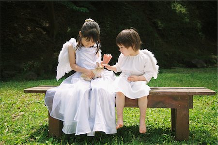 sister sits on brother laps photos - Angels Playing with Rabbit Stock Photo - Rights-Managed, Code: 859-03781937