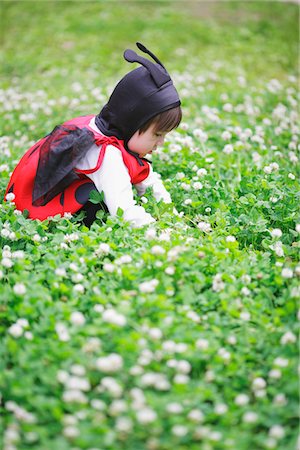 Boy Dressed as Ladybird Sitting in Field Stock Photo - Rights-Managed, Code: 859-03781965