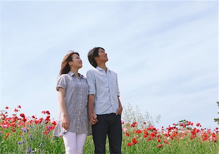 red lifestyle spring - Couple Standing Holding Hands in Field of Flowers Stock Photo - Rights-Managed, Code: 859-03782058