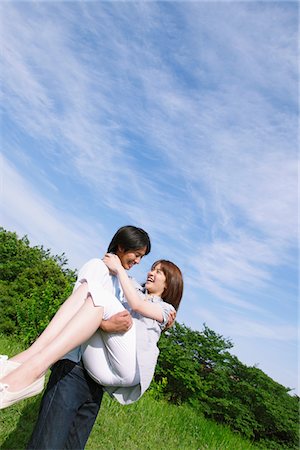 romantic husband carries wife images - Man Carrying Wife in his Arms Stock Photo - Rights-Managed, Code: 859-03782066