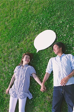 Couple Lying  on Grass Holding Hands Stock Photo - Rights-Managed, Code: 859-03782077