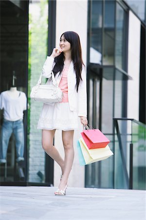 Young Woman with Purse and Shopping Bags Stock Photo - Rights-Managed, Code: 859-03782106