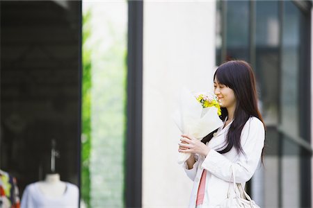 simsearch:632-01271797,k - Young Woman Smelling Flowers and Smiling Stock Photo - Rights-Managed, Code: 859-03782113