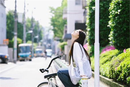 Young Woman  Sitting on Roadside Railing with Bicycle Stock Photo - Rights-Managed, Code: 859-03782136