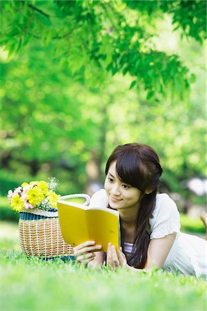 Young Woman Lying on Grass and Reading Book Stock Photo - Rights-Managed, Code: 859-03782241