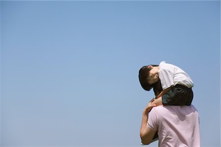 Father Carrying Son on his Shoulders Stock Photo - Rights-Managed, Code: 859-03782273