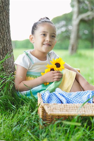simsearch:859-03782433,k - Girl Holding Flowers Sitting in Park Stock Photo - Rights-Managed, Code: 859-03782414