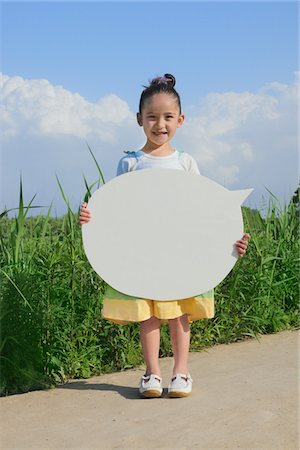 Girl Standing in Park Holding Board Stock Photo - Rights-Managed, Code: 859-03782436