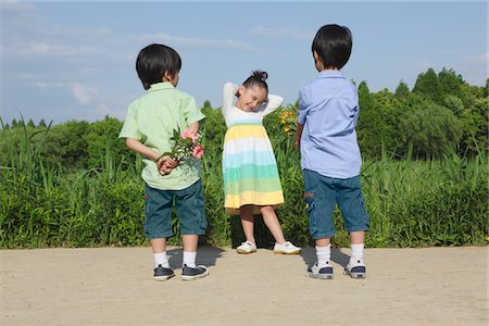 Boys Offering Flowers to Girl Stock Photo - Rights-Managed, Code: 859-03782445