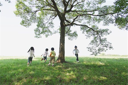 Children Playing In Grassy Field Stock Photo - Rights-Managed, Code: 859-03805780