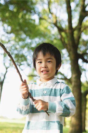 simsearch:859-03839830,k - Smiling Boy Holding a Twig Stock Photo - Rights-Managed, Code: 859-03805804