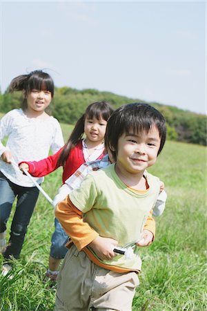 followers - Playing In Grassy Field Stock Photo - Rights-Managed, Code: 859-03805819