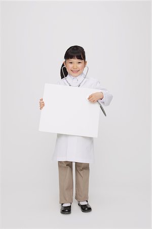 doctor full body white background - Girl Dressed Up As Doctor Holding Placard Stock Photo - Rights-Managed, Code: 859-03806108
