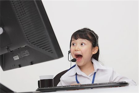 escritorio (pantalla del monitor) - Excited Girl as Businesswoman Foto de stock - Con derechos protegidos, Código: 859-03806179