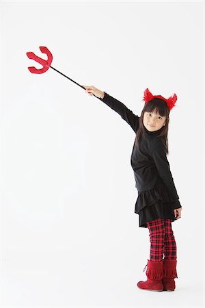 silhouette child - Girl Dressed In Halloween Devil Pointing With Trident Stock Photo - Rights-Managed, Code: 859-03806282