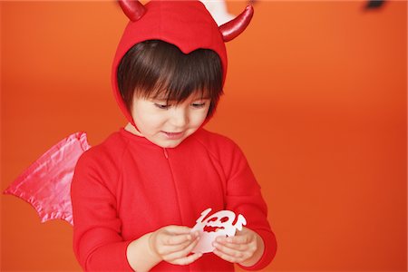 Boy Dressed Up As Devil against Holding Ghost Stock Photo - Rights-Managed, Code: 859-03806346