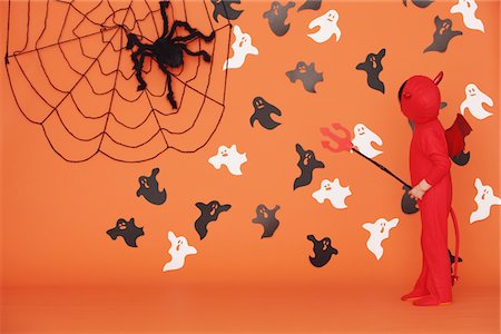 dreading - Boy Dressed Up As Devil against Orange Background Stock Photo - Rights-Managed, Code: 859-03806343