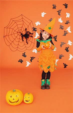 Girl Dressed In Costume for Halloween Holding Pumpkin Fotografie stock - Rights-Managed, Codice: 859-03806369