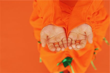 simsearch:693-03301293,k - Human Hands against Orange Background Stock Photo - Rights-Managed, Code: 859-03806371