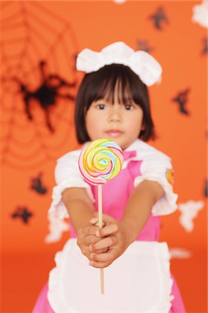 Japanese Girl Holding Lollypop Stock Photo - Rights-Managed, Code: 859-03806387