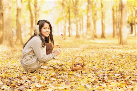 preteen girls playing at park photos - Girl In Park In The Autumn Leaves Stock Photo - Rights-Managed, Code: 859-03839339