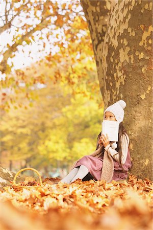 Girl Leaning Against A Tree With A Book Stock Photo - Rights-Managed, Code: 859-03839353