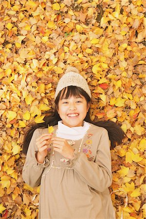 Preteen Girl Lying In Leaves Stock Photo - Rights-Managed, Code: 859-03839369