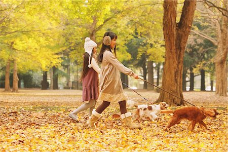 preteen animal not adult not eye contact - Girls Walking With Their Dog In Park Stock Photo - Rights-Managed, Code: 859-03839396