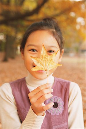 falling leaves - Preteen Girl Holding Maple Leaf Stock Photo - Rights-Managed, Code: 859-03839421