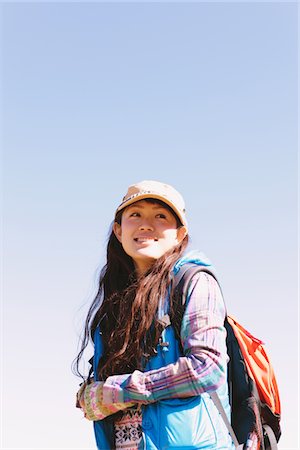 esploratrice - Young Woman Smiling And Looking Away Fotografie stock - Rights-Managed, Codice: 859-03839462