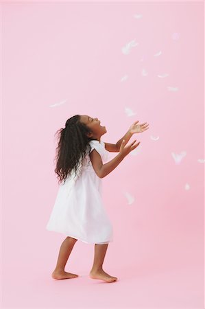 Girl Catching Feathers Fotografie stock - Rights-Managed, Codice: 859-03839806